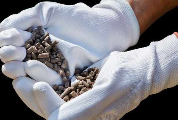 27991827 - brown manure granules in white gloves on farmer's hands.